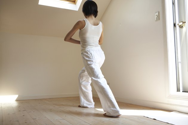 Young woman performing yoga pose in home