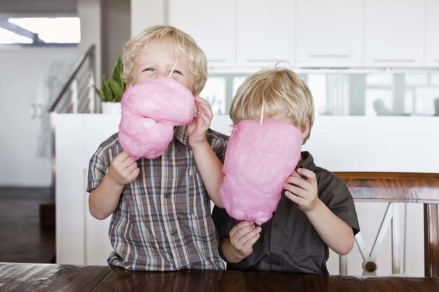 Twin boys with cotton candy