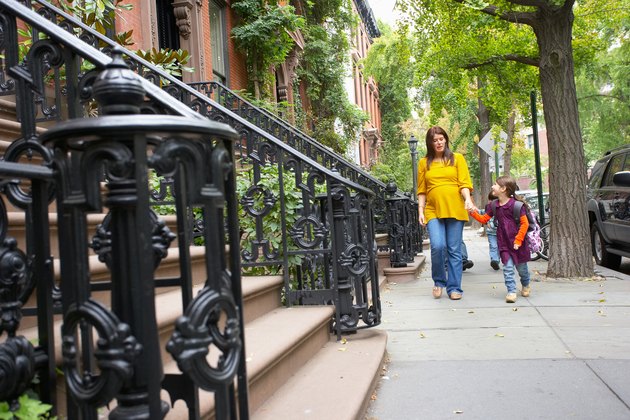 Mother and daughter walking in neighborhood, Manhattan, New York City