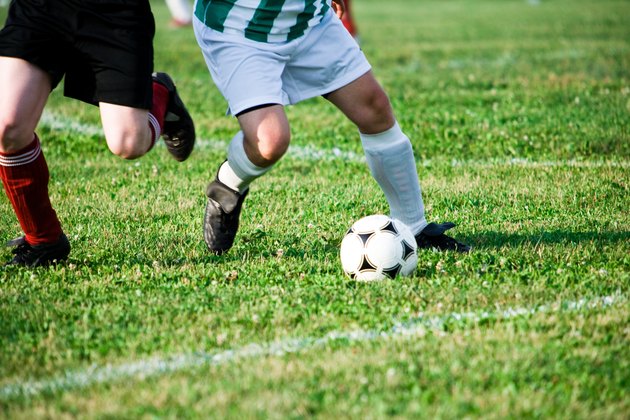 Two soccer players competing for ball