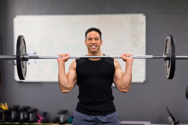 muscular man lifting weights