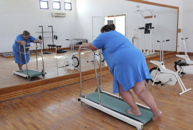 overweight woman running on trainer treadmill