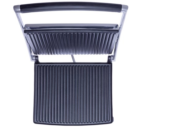Open panini press showing the cast iron plates