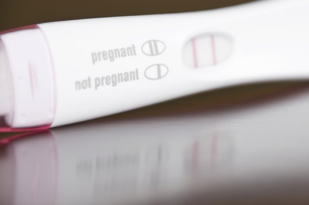 Positive Pregnancy Test Close-Up on a Brown Wooden Table