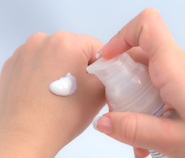 Woman hands holding cream.