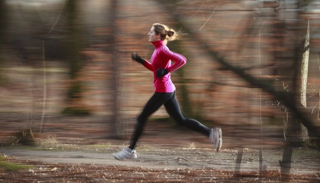 Young woman running outdoors in a city park