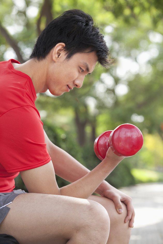 Young Man exercising with Dumbbell