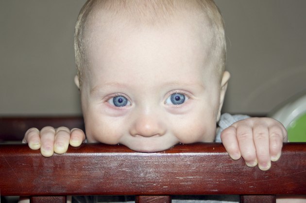 Baby Chewing on Crib