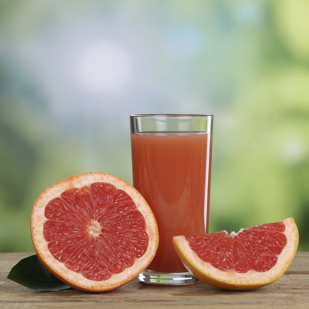 Grapefruit juice and fresh grapefruits fruits in summer