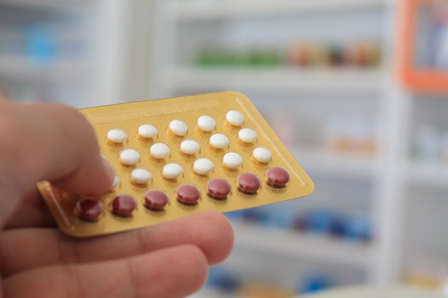Close up of pharmacist hands holding contraceptive pills