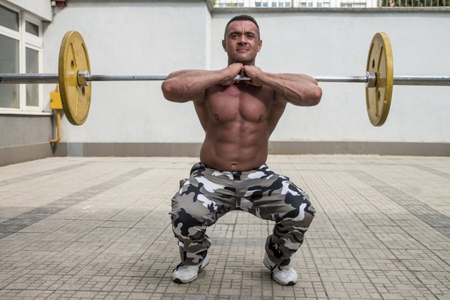 Bodybuilder Doing Front Squats With Barbells