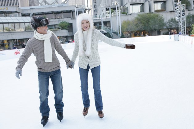 Mature couple ice skating together
