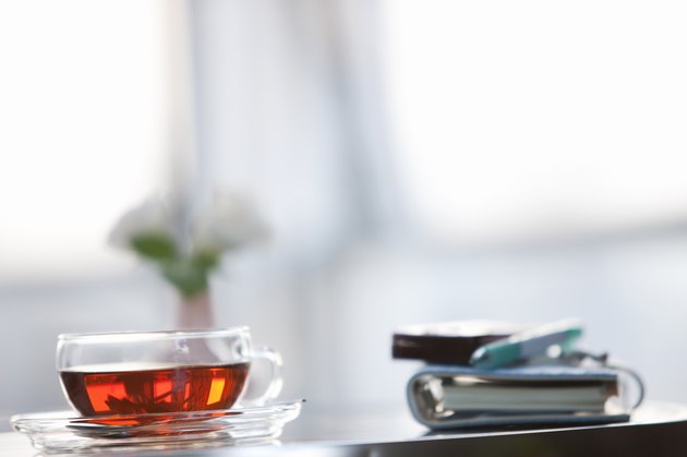 Cup of tea on a table with a cellphone and diary