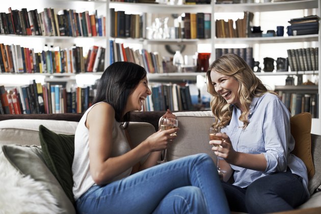 Women sitting on sofa laughing