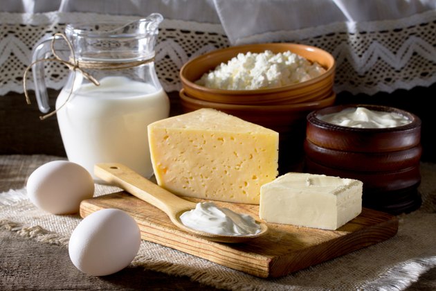 Homemade dairy products and eggs on a wooden table.