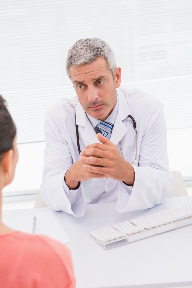 Patient consulting a serious doctor