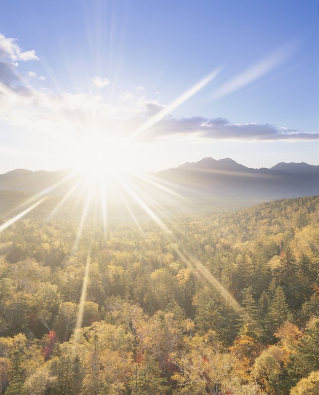 The Sun Rising Over a Mountain Range and a Forest. Japan