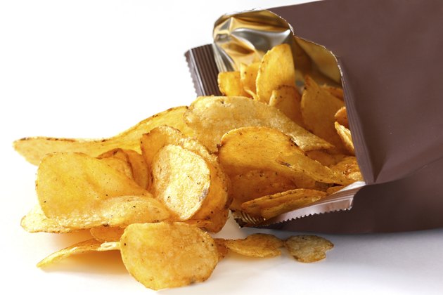 Open packet of crisps on white