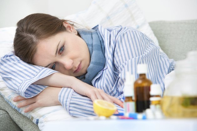 Sick woman lying in bed