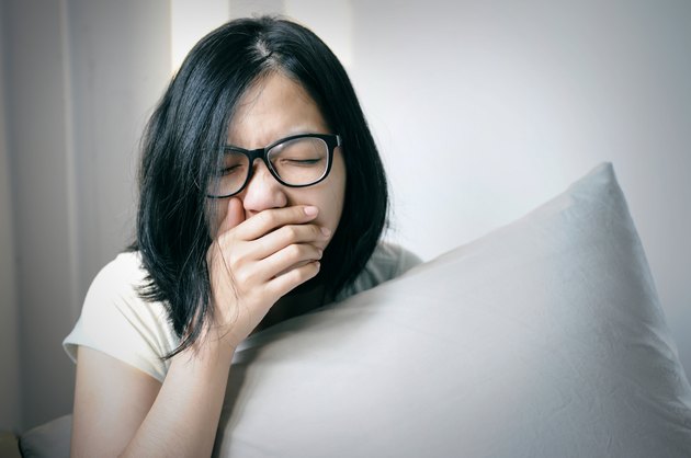 Asian women sneeze and cough on her bed