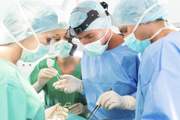 Surgeons operating patient in operation theater