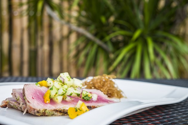 Grilled tuna steak slices with mango-melon salsa