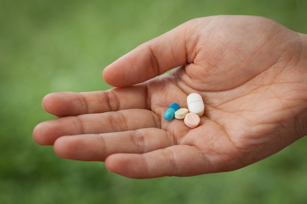 Closeup pills on woman hand