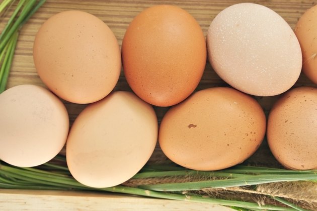 Close up of Eggs in wooden box with grass