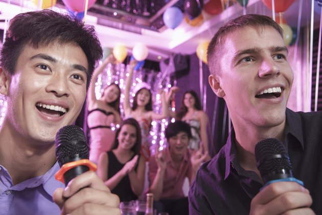 Two friends singing together at karaoke