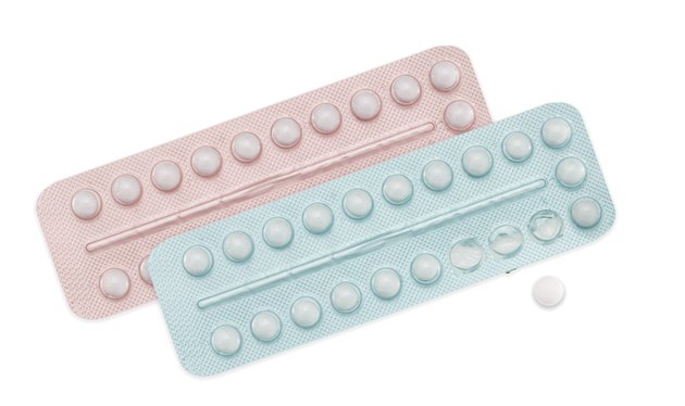 Male and female contraceptive pills, pink, blue on white