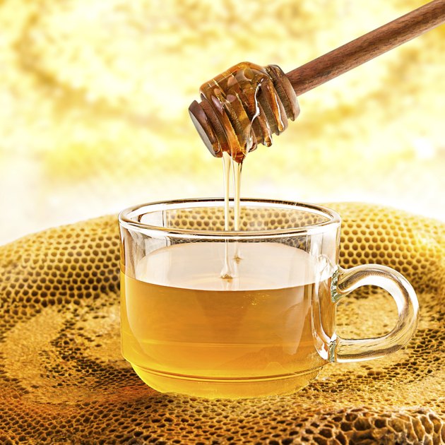 Glass of honey and honeycomb