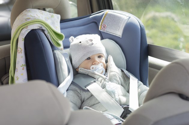 Baby boy in his child safety car seat