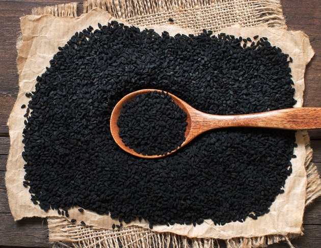 Nigella sativa or Black cumin with a spoon