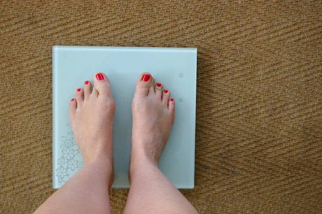 Woman weighing herself