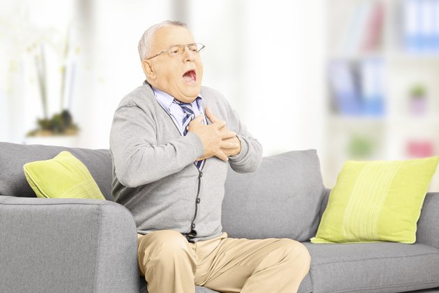 Senior man having a heart attack at home