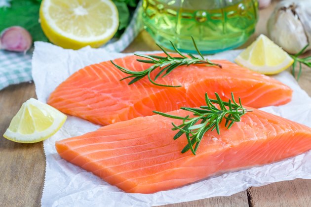 Fresh raw salmon fillet with rosemary and lemon