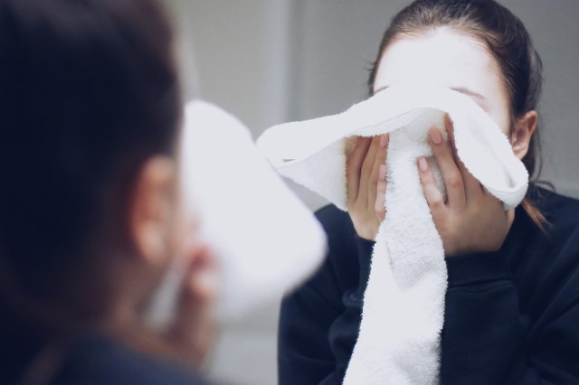 woman washing her face