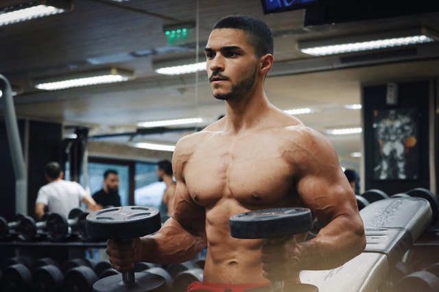 man strength training at the gym