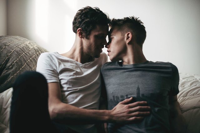 young couple sharing a kiss in bed