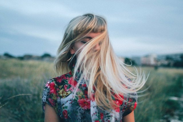 woman flipping hair outdoors