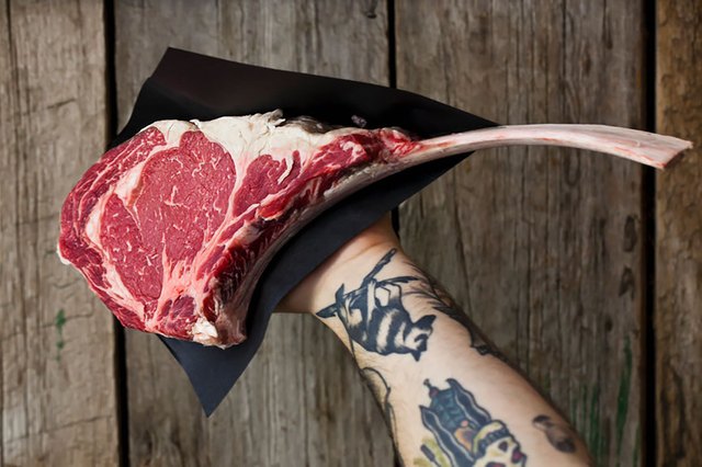 man holding steak
