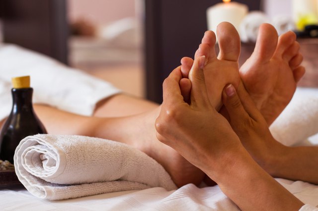 Massage of human foot in spa salon - Soft focus