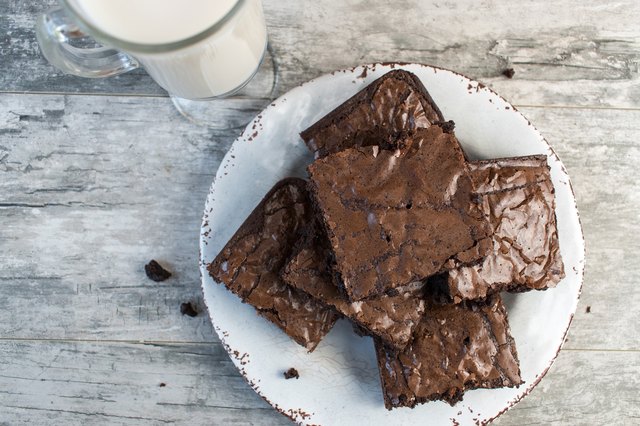 Chocolate brownies on white plate with milk