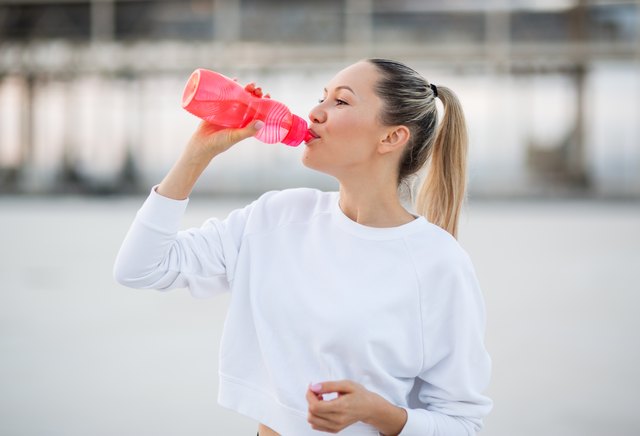 Fitness woman drinking water