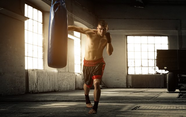 Young pretty boxer woman standing on ring. Full body portrait of