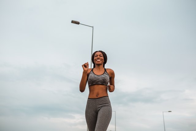 Healthy young african american woman running in urban environment
