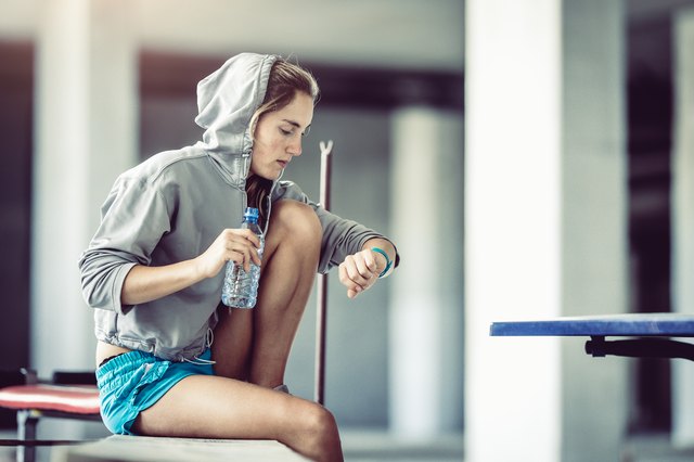 Female Athlete Checking Her Heart Rate on a Fitness Tracker
