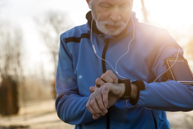 Senior Man using Smart Watch measuring heart rate