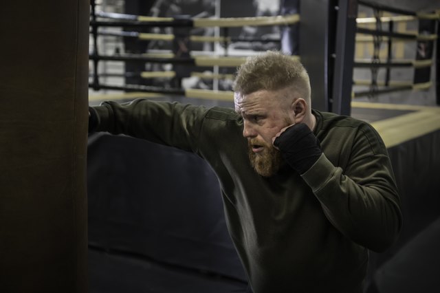 MMA Fighter Practicing With Boxing Bag.