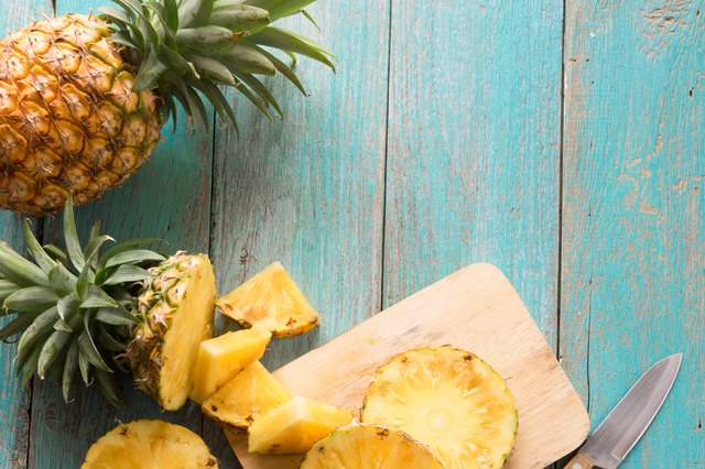Directly Above Shot Of Pineapple With Slices On Table